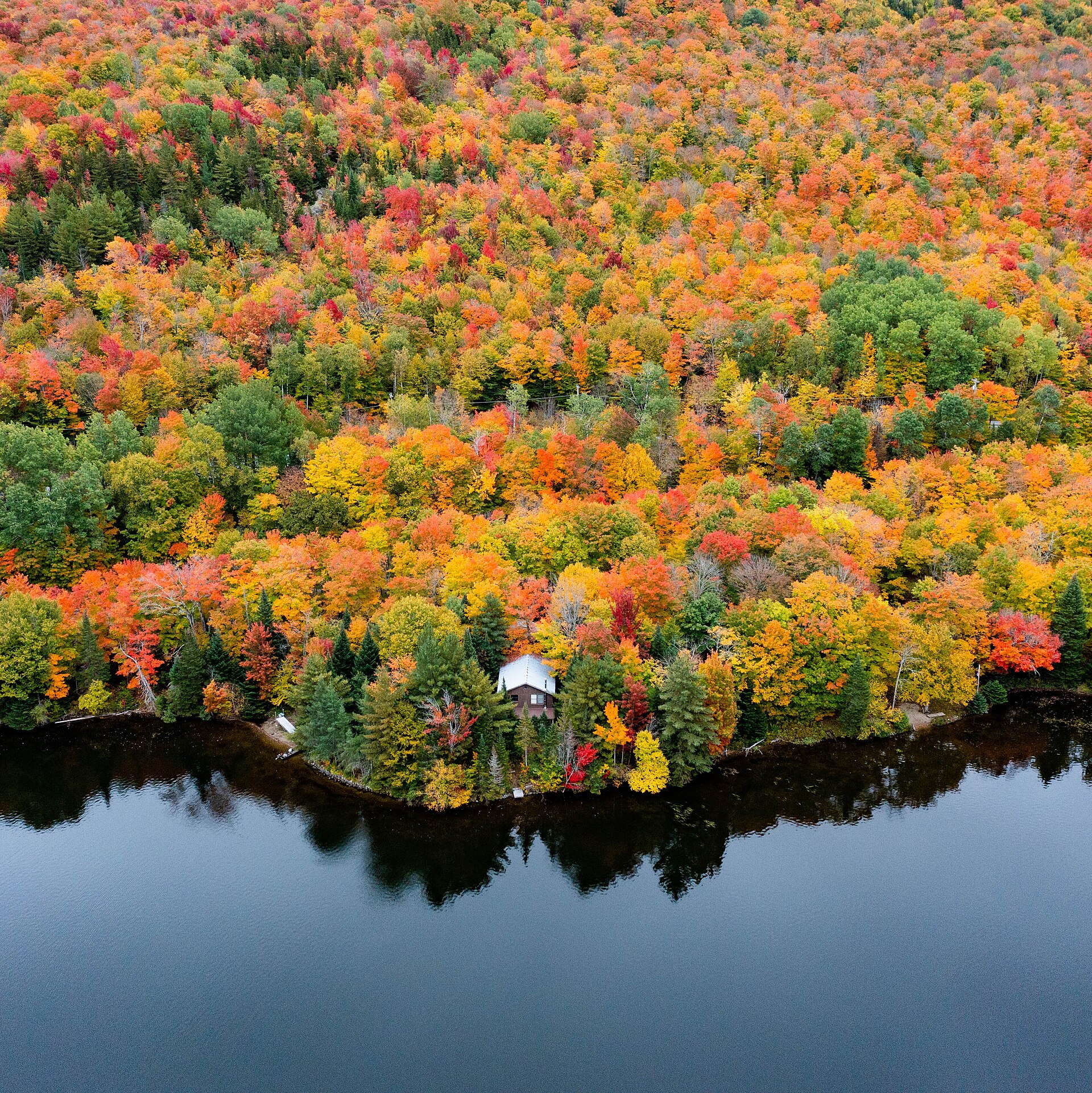 Aerial file photograph of bright autumn foliage surrounding Norton Pond in Vermont’s Northeast Kingdom